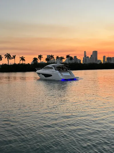  Yacht Photos Pics 2024 Sessa Marine C44 Cruiser on water at sunset with city skyline.