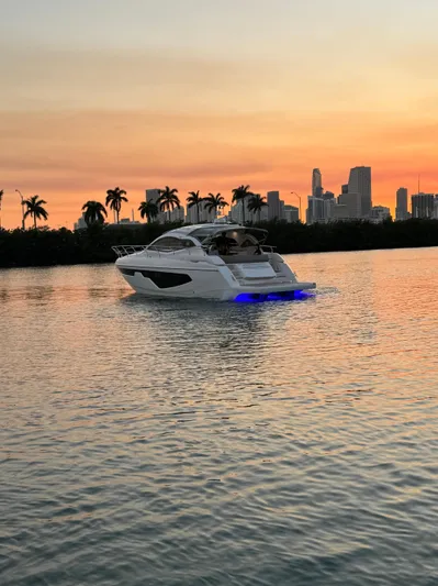  Yacht Photos Pics 2024 Sessa Marine C44 Cruiser on water at sunset with city skyline.