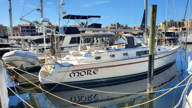  Yacht Photos Pics 1999 Beneteau Oceanis 44 CC sailboat docked in a marina.