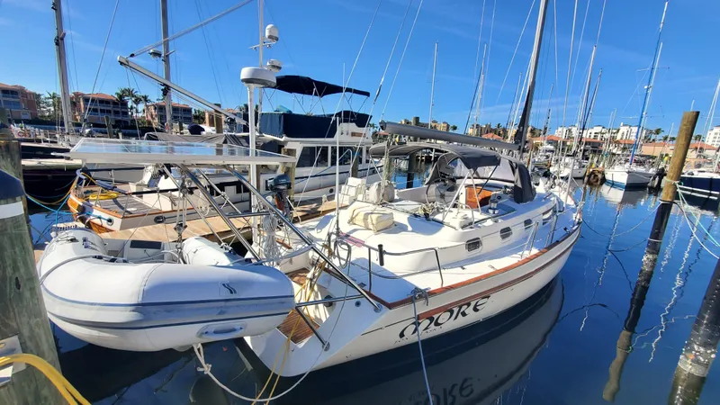  Yacht Photos Pics 1999 Beneteau Oceanis 44 CC sailboat docked in a marina, surrounded by other boats.