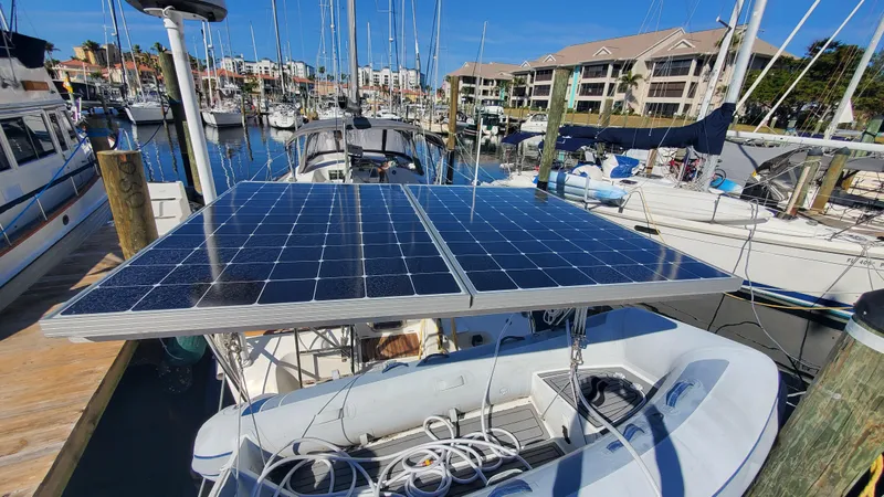  Yacht Photos Pics Beneteau Oceanis 44 CC 1999 with solar panels docked in a marina.