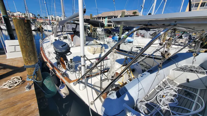  Yacht Photos Pics 1999 Beneteau Oceanis 44 CC sailboat docked in a marina under clear blue skies.