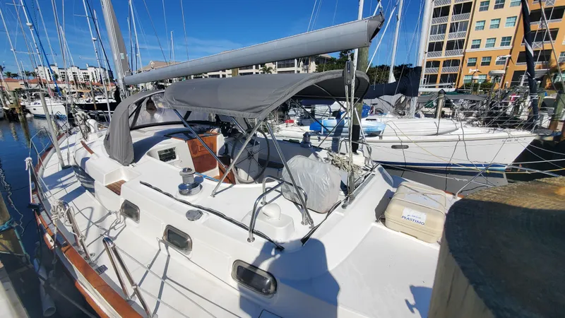  Yacht Photos Pics 1999 Beneteau Oceanis 44 CC sailboat docked at marina under clear blue sky.