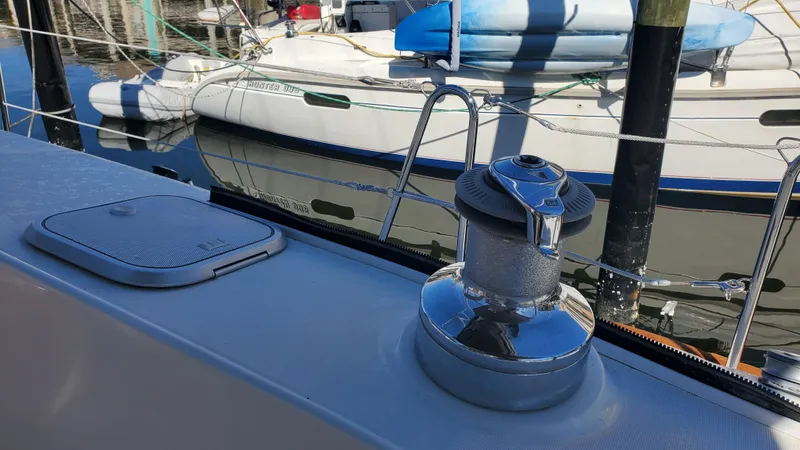  Yacht Photos Pics Deck view of a 1999 Beneteau Oceanis 44 CC sailboat with winch and moored boats.