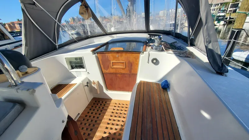  Yacht Photos Pics 1999 Beneteau Oceanis 44 CC cockpit with wooden flooring and covered seating area.
