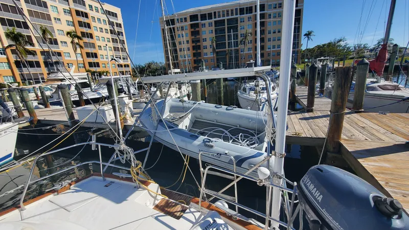  Yacht Photos Pics Beneteau Oceanis 44 CC 1999 docked at marina with nearby buildings.