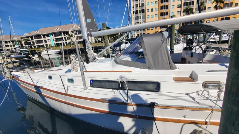  Yacht Photos Pics 1999 Beneteau Oceanis 44 CC sailboat docked in marina, sunny day.