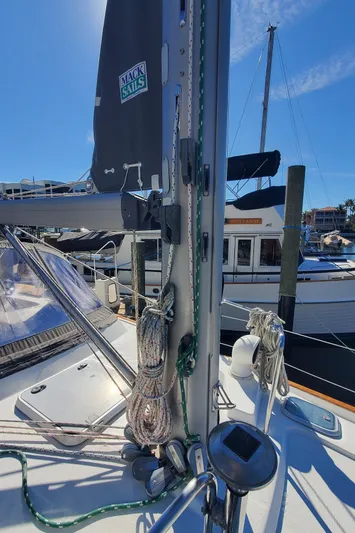  Yacht Photos Pics 1999 Beneteau Oceanis 44 CC sailboat deck with mast and rigging in marina.