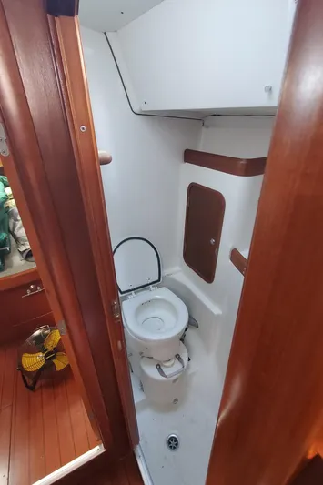  Yacht Photos Pics 1999 Beneteau Oceanis 44 CC yacht bathroom with wooden accents and compact design.