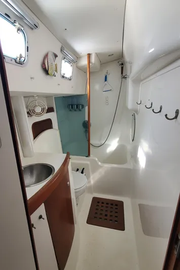  Yacht Photos Pics Interior of 1999 Beneteau Oceanis 44 CC yacht bathroom with sink and shower.