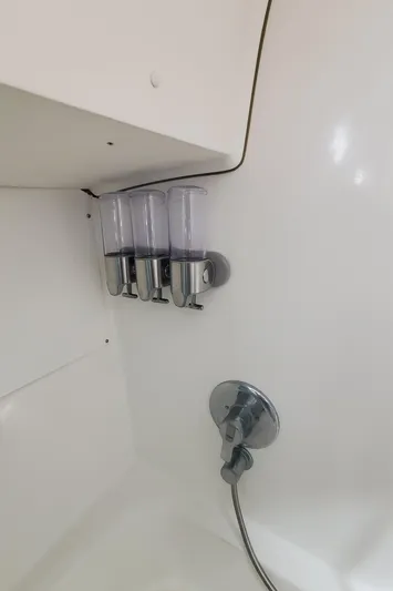  Yacht Photos Pics Shower area in 1999 Beneteau Oceanis 44 CC yacht with dispensers and chrome fixtures.