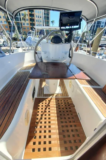  Yacht Photos Pics Cockpit of 1999 Beneteau Oceanis 44 CC sailboat with wooden flooring and steering wheel.