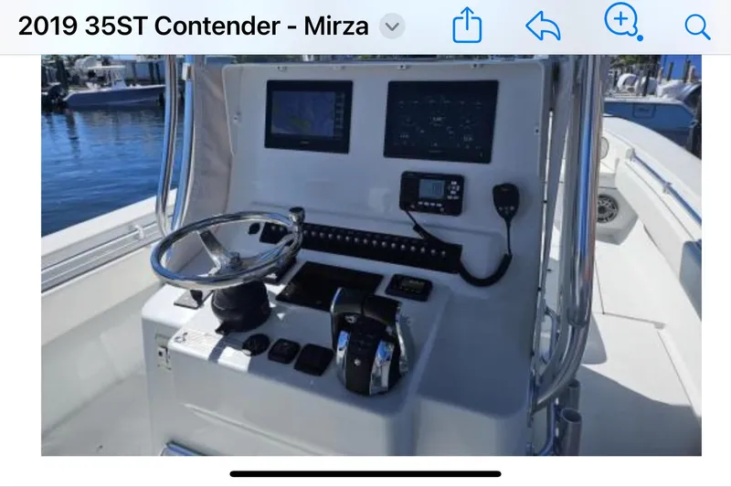  Yacht Photos Pics 2019 Contender 35 ST boat dashboard with steering wheel and navigation controls.
