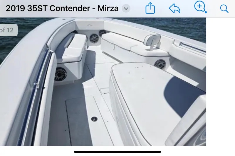  Yacht Photos Pics 2019 Contender 35 ST boat interior with white seating and ocean backdrop.