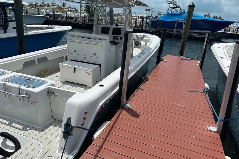  Yacht Photos Pics 2019 Contender 35 ST boat docked at marina with red wooden pier.
