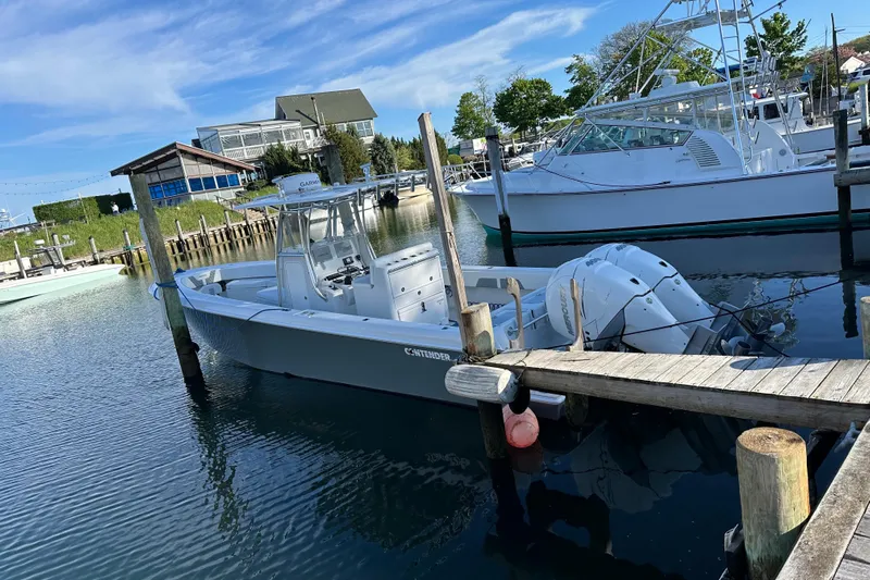  Yacht Photos Pics 2019 Contender 35 ST boat docked in a marina with clear blue skies.
