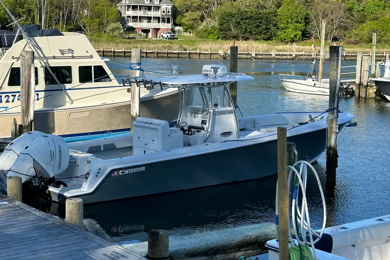  Yacht Photos Pics 2019 Contender 35 ST boat docked in a marina, featuring sleek design and powerful engines.