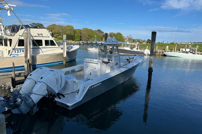  Yacht Photos Pics 2019 Contender 35 ST boat docked in a serene marina setting.