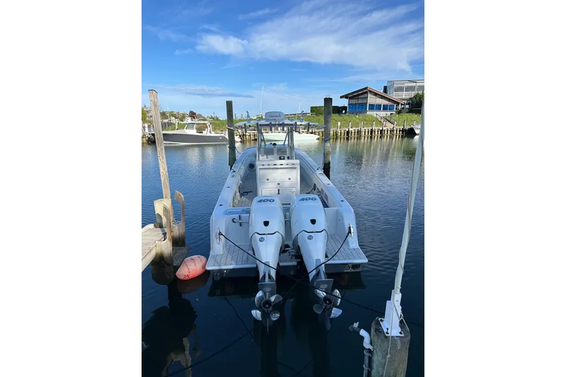  Yacht Photos Pics 2019 Contender 35 ST boat docked with twin 400 engines, clear sky background.