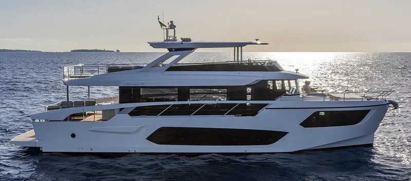 Absolute Navetta 75 Yacht Photos Pics 2025 Absolute NAVETTA 75 yacht cruising on open sea at sunset.
