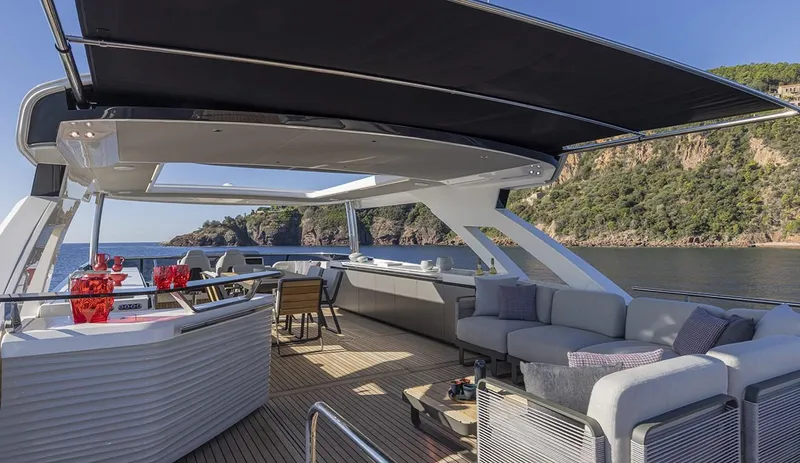 Absolute Navetta 75 Yacht Photos Pics Luxurious 2025 Absolute NAVETTA 75 yacht deck with modern seating and scenic ocean view.