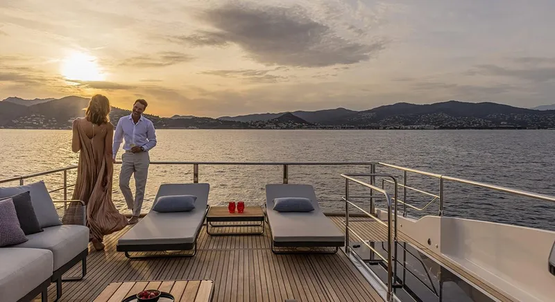 Absolute Navetta 75 Yacht Photos Pics Couple enjoying sunset on Absolute NAVETTA 75 yacht deck, 2025 model.