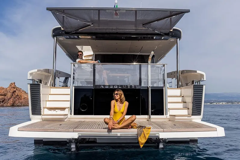 Absolute Navetta 75 Yacht Photos Pics Luxury Absolute NAVETTA 75 yacht, 2025 model, with people relaxing on the deck.