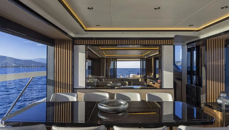 Absolute Navetta 75 Yacht Photos Pics Luxurious interior of 2025 Absolute NAVETTA 75 yacht with elegant dining area and sea view.