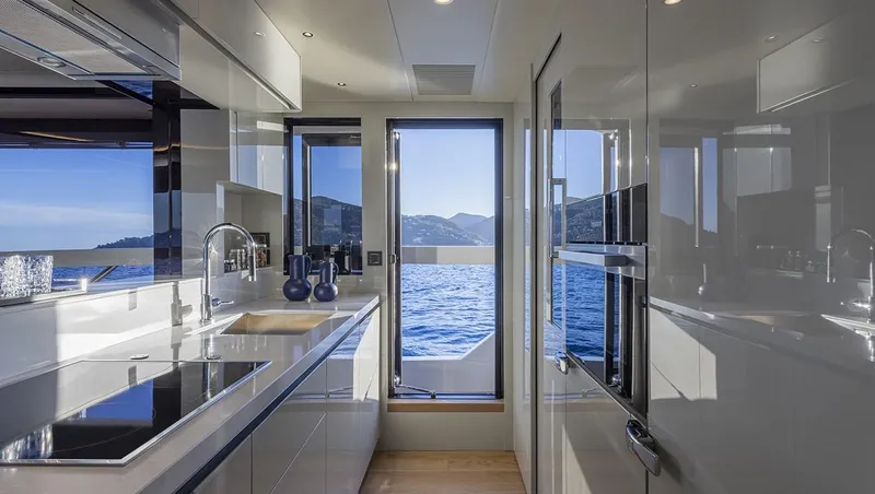 Absolute Navetta 75 Yacht Photos Pics Luxurious kitchen interior of 2025 Absolute NAVETTA 75 yacht with ocean view.