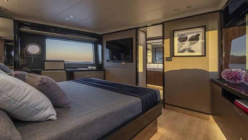 Absolute Navetta 75 Yacht Photos Pics Luxurious bedroom interior of 2025 Absolute NAVETTA 75 yacht with modern decor and ocean view.