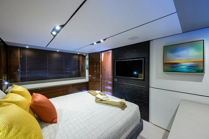 Gallant Lady Yacht Photos Pics Luxurious bedroom interior of 2018 Princess 65S yacht with modern decor and vibrant cushions.