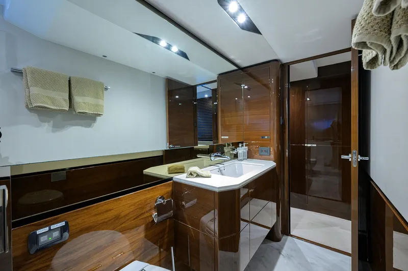 Gallant Lady Yacht Photos Pics Luxurious bathroom interior of 2018 Princess 65S yacht with modern fixtures and wooden accents.