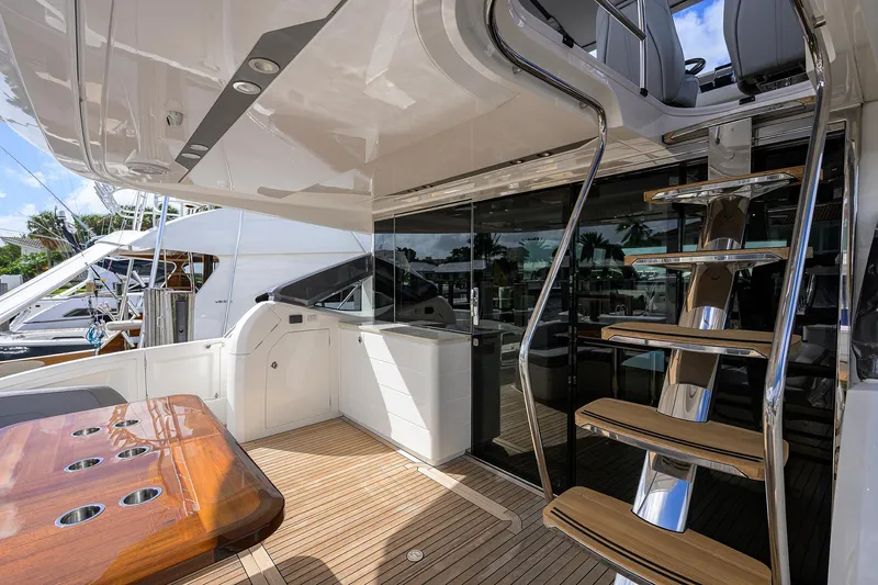 Gallant Lady Yacht Photos Pics Luxurious 2018 Princess 65S yacht deck with wooden table and sleek staircase.