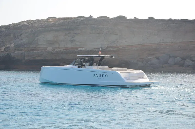 Ban Ban Yacht Photos Pics 2023 Pardo Yachts 50 cruising in clear blue waters near rocky coastline.