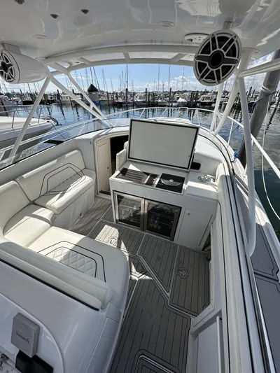 377 Walkaround Cuddy Yacht Photos Pics 2002 Intrepid 377 Walkaround Cuddy boat interior with seating and helm station.