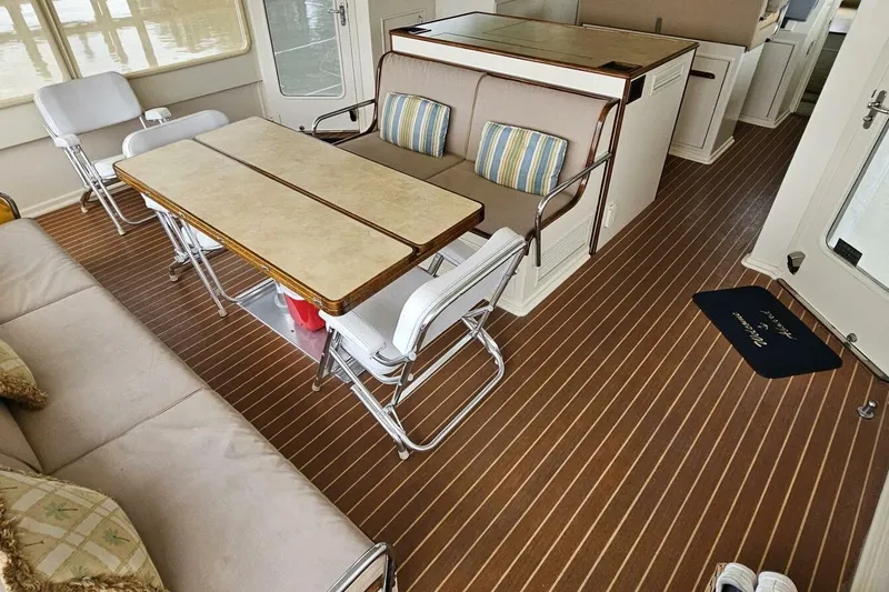Summer Song Yacht Photos Pics Interior of 1969 Derecktor 68 Hunt Motor Yacht with seating and dining area.