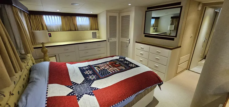 Summer Song Yacht Photos Pics Luxurious bedroom interior of 1969 Derecktor Hunt M.Y. yacht with patriotic-themed bedspread.