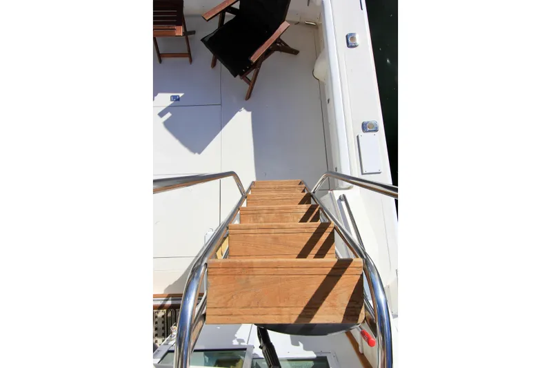 La Dorada Yacht Photos Pics Teak steps on custom welded flybridge ladder.