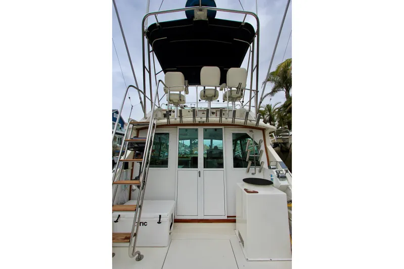 La Dorada Yacht Photos Pics 1980 Bertram 35 Flybridge boat with ladder and seating area.