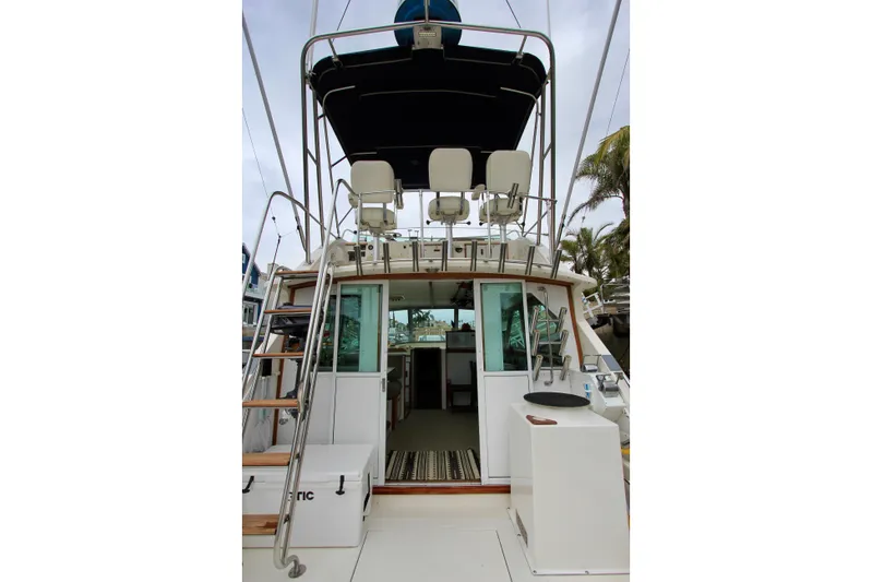 La Dorada Yacht Photos Pics 1980 Bertram 35 Flybridge yacht with upper deck seating and ladder access.