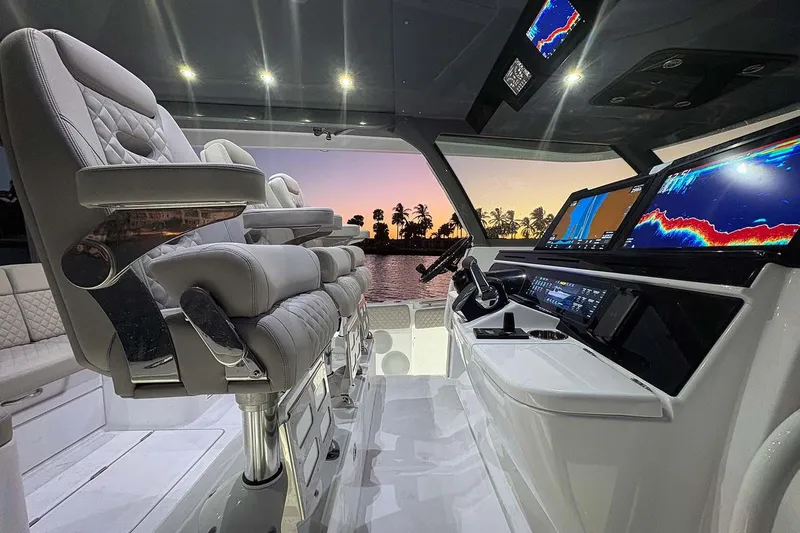  Yacht Photos Pics Manufacturer Provided Image: 2026 HCB 56 Suenos GIX helm with luxurious seating and advanced navigation displays at sunset.