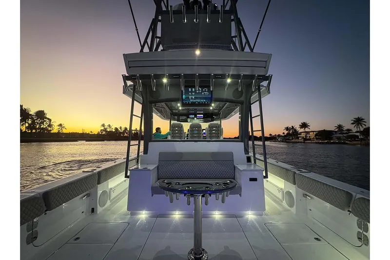  Yacht Photos Pics Manufacturer Provided Image: 2026 HCB 56 Suenos GIX boat at sunset, featuring illuminated deck and seating.