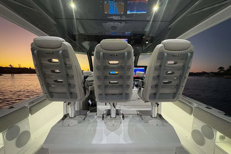 Yacht Photos Pics Manufacturer Provided Image: Interior of 2026 HCB 56 Suenos GIX boat at sunset, featuring modern seating and controls.