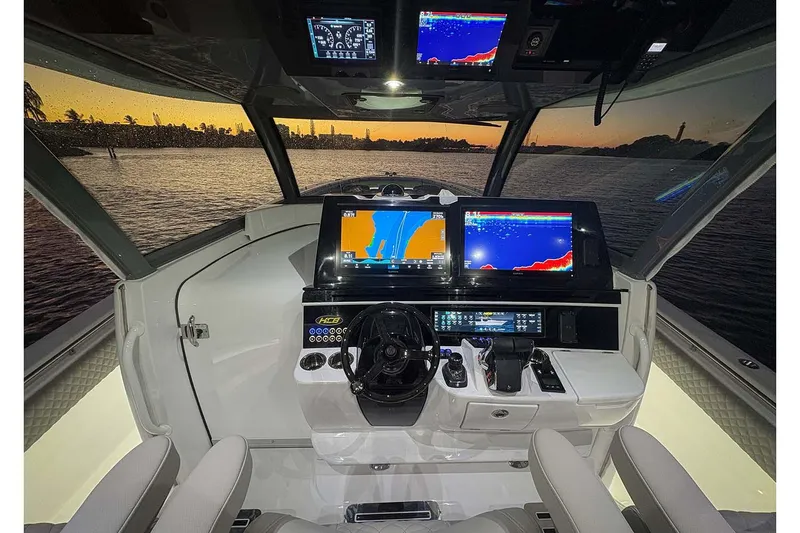  Yacht Photos Pics Manufacturer Provided Image: 2026 HCB 56 Suenos GIX helm with advanced navigation screens at sunset.