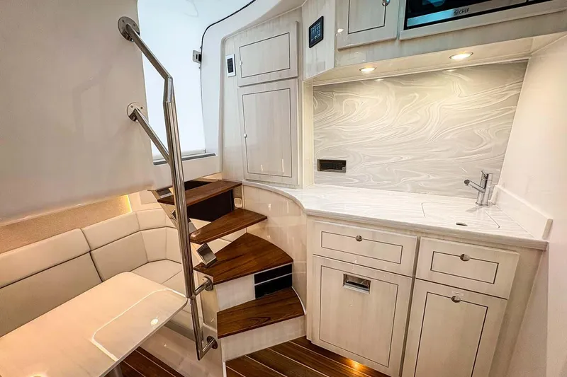  Yacht Photos Pics Manufacturer Provided Image: Luxurious interior of 2026 HCB 56 Suenos GIX yacht with modern kitchenette and seating area.