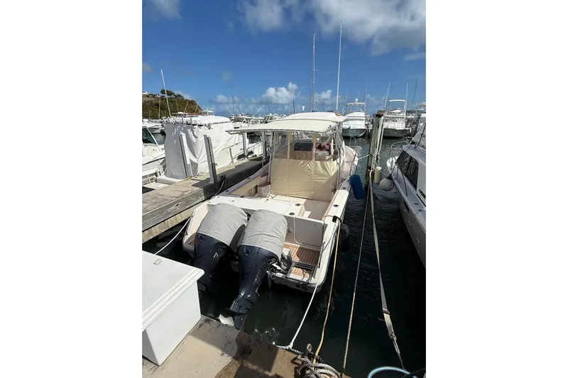  Yacht Photos Pics 2008 Grady-White Marlin 300 boat docked at a marina under a clear blue sky.