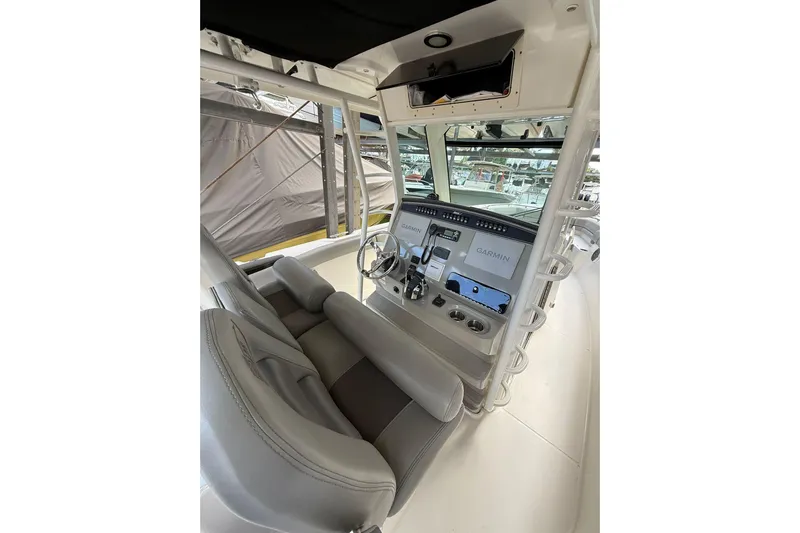  Yacht Photos Pics 2016 Boston Whaler 330 Outrage helm with Garmin navigation system and comfortable seating.