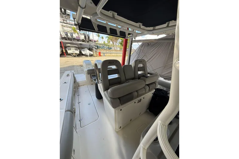  Yacht Photos Pics 2016 Boston Whaler 330 Outrage interior with cushioned seating and storage.