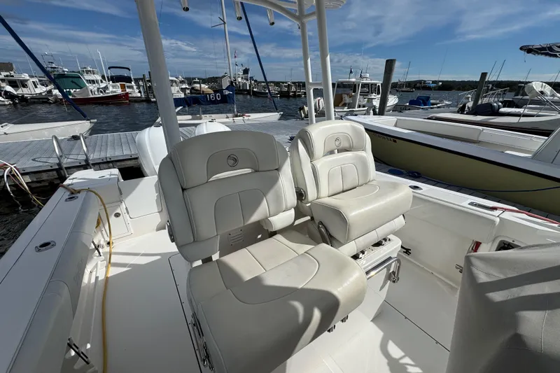 Lady Grey Yacht Photos Pics 2016 Edgewater 320CC boat interior with plush seating at a marina dock.