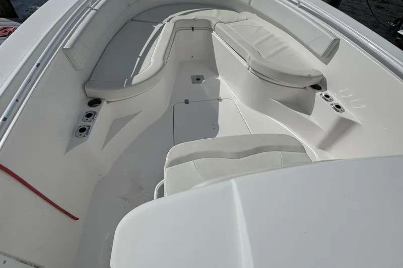 Lady Grey Yacht Photos Pics Interior view of a 2016 Edgewater 320CC boat, featuring white seating and cup holders.